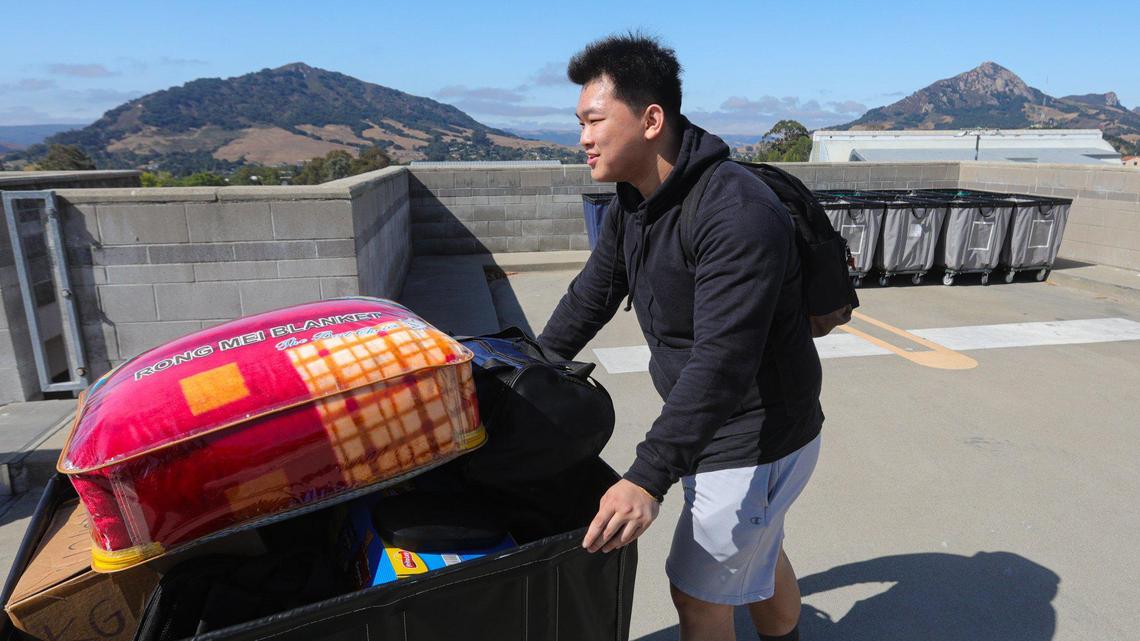 Environmental engineering major Eric Giang, 18, unloads his gear at the parking structure as more than 8,800 students began to move in to on campus housing at Cal Poly beginning on Sept. 14, 2023.