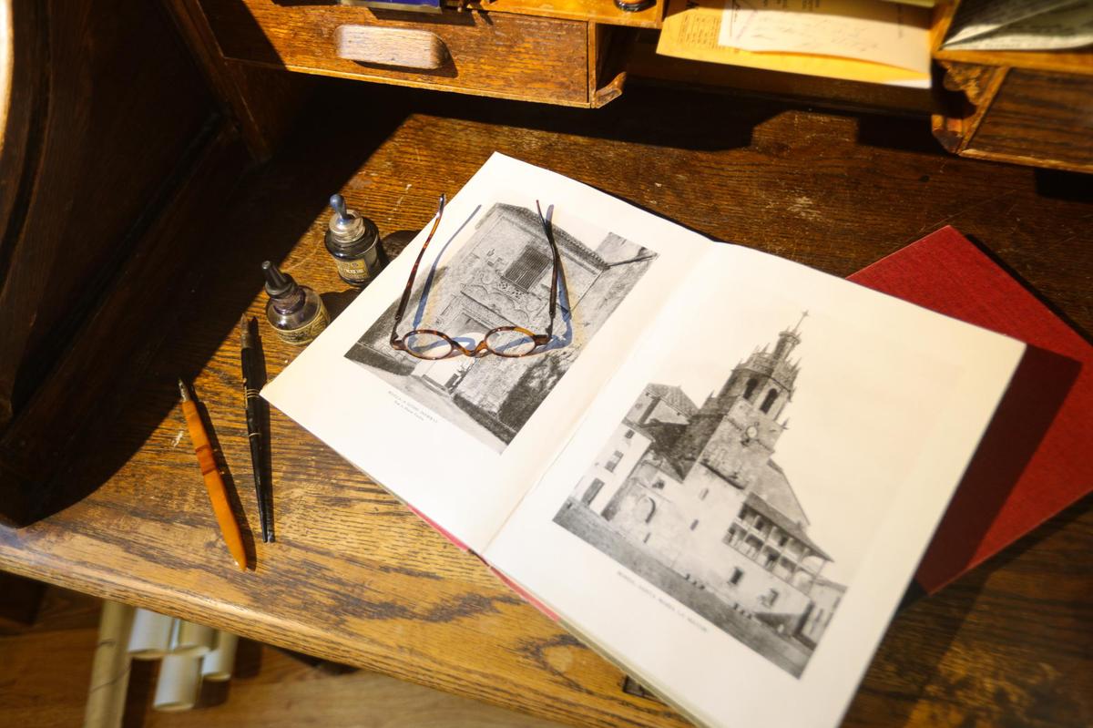 The book on the desk is open to photos of European architecture that inspired Hearst Castle designs and the glasses are similar to the ones that architect Julia Morgan wore. New displays at the Hearst Castle Visitor Center highlight the people who built the San Simeon home of newspaper magnate William Randolph Hearst.