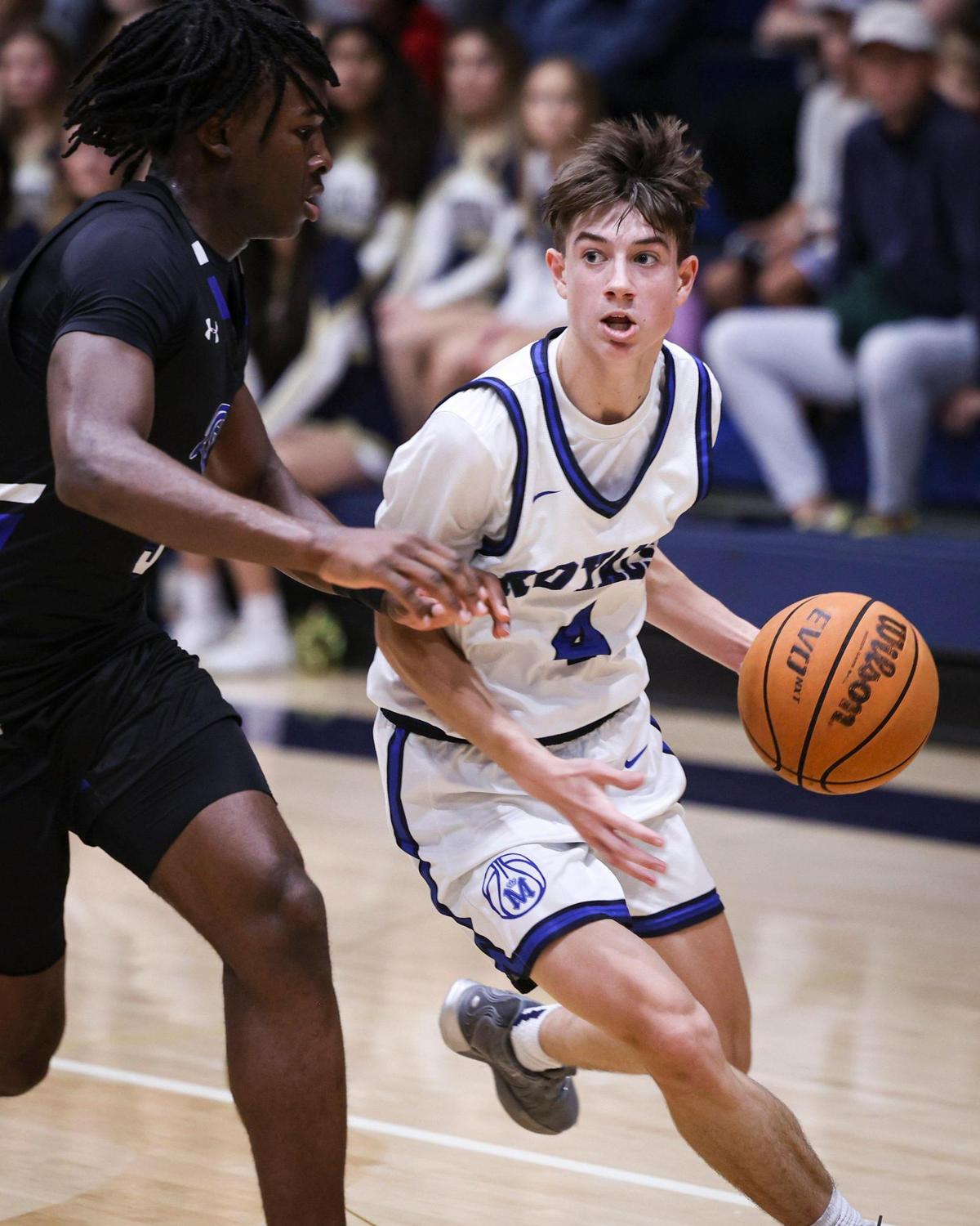 Brody Miller drives to the basket defended by Nsongbeh Ginyui. Mission Prep beat Frontier 67-55 on Feb. 21, 2025, to advance to the Division 2 CIF Central Section basketball final.