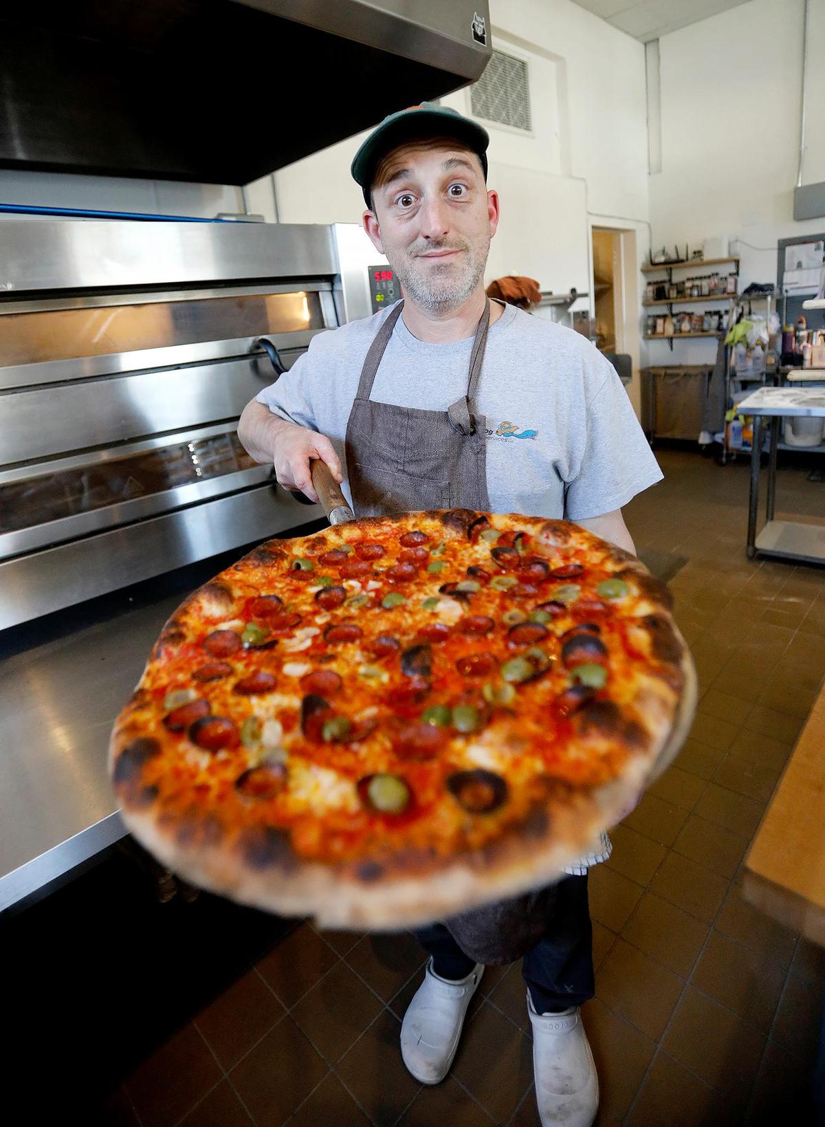 Owner, Mike Radakovich is proud of his pizza pies where they select locally grown vegetable, sausage from Catteno Brothers and house made sour dough pizza crust.