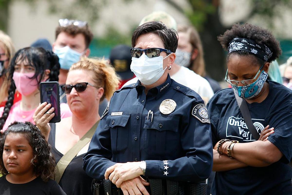 San Luis Obispo police Chief Deanna Cantrell listen as RACE Matters SLO County held a rally in late May at Mitchell Park to protest violence against people of color in America.