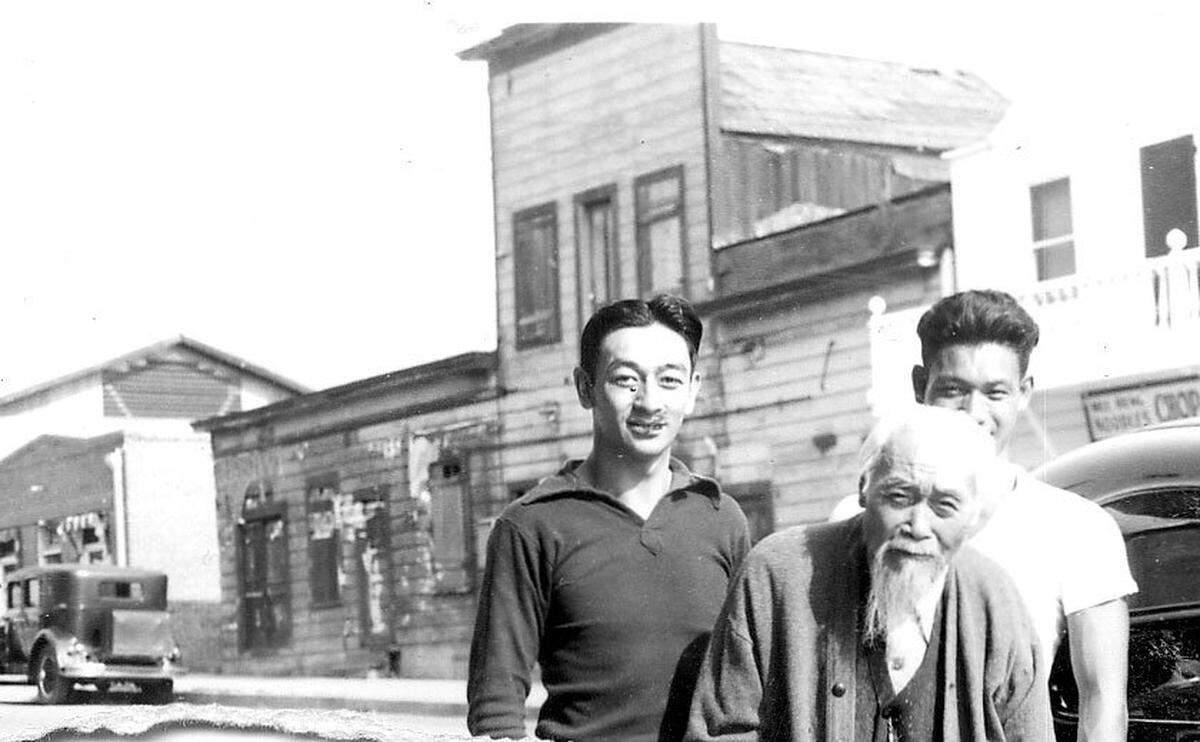 Howard and Fred Louis and their father Ah Louis in front of the family store in 1936.
