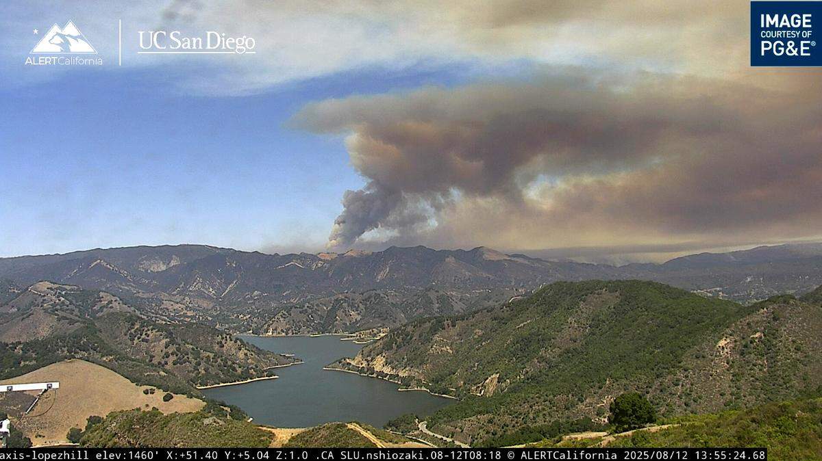 The Gifford Fire sends up a dark column of smoke in a view from Lopez Lake while burning in San Luis Obispo County’s Garcia Wilderness on Aug. 12, 2025.
