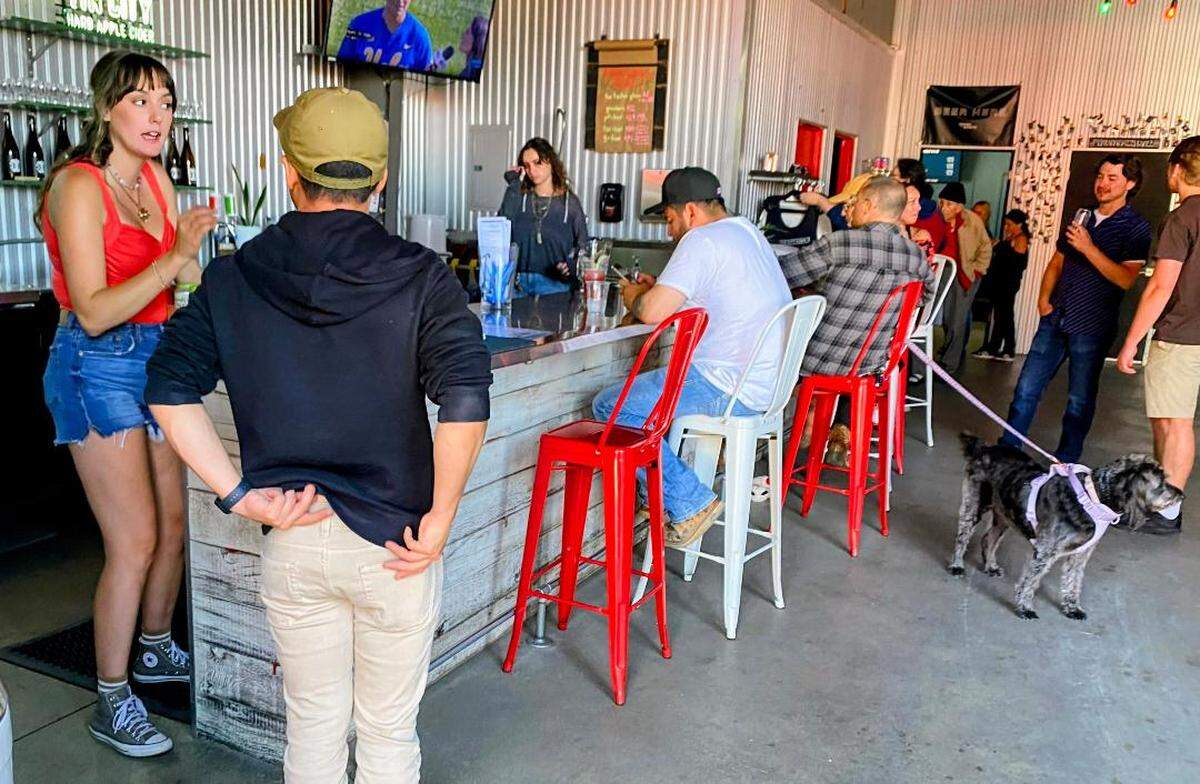 Customers gather at the bar inside Tin City Cider Co. in Paso Robles on May 23, 2026.