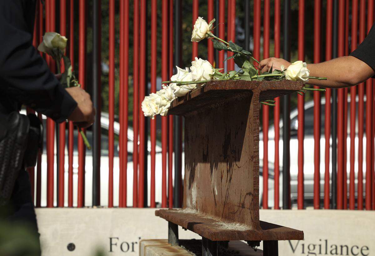 Community members placed roses on a 10-foot steel beam from the rubble of the World Trade Center on Sept 11, 2025. About 60 people gathered at San Luis Obispo Fire Station 1 to honor the sacrifices made responding to the terrorist attacks that took place on Sept. 11, 2001.