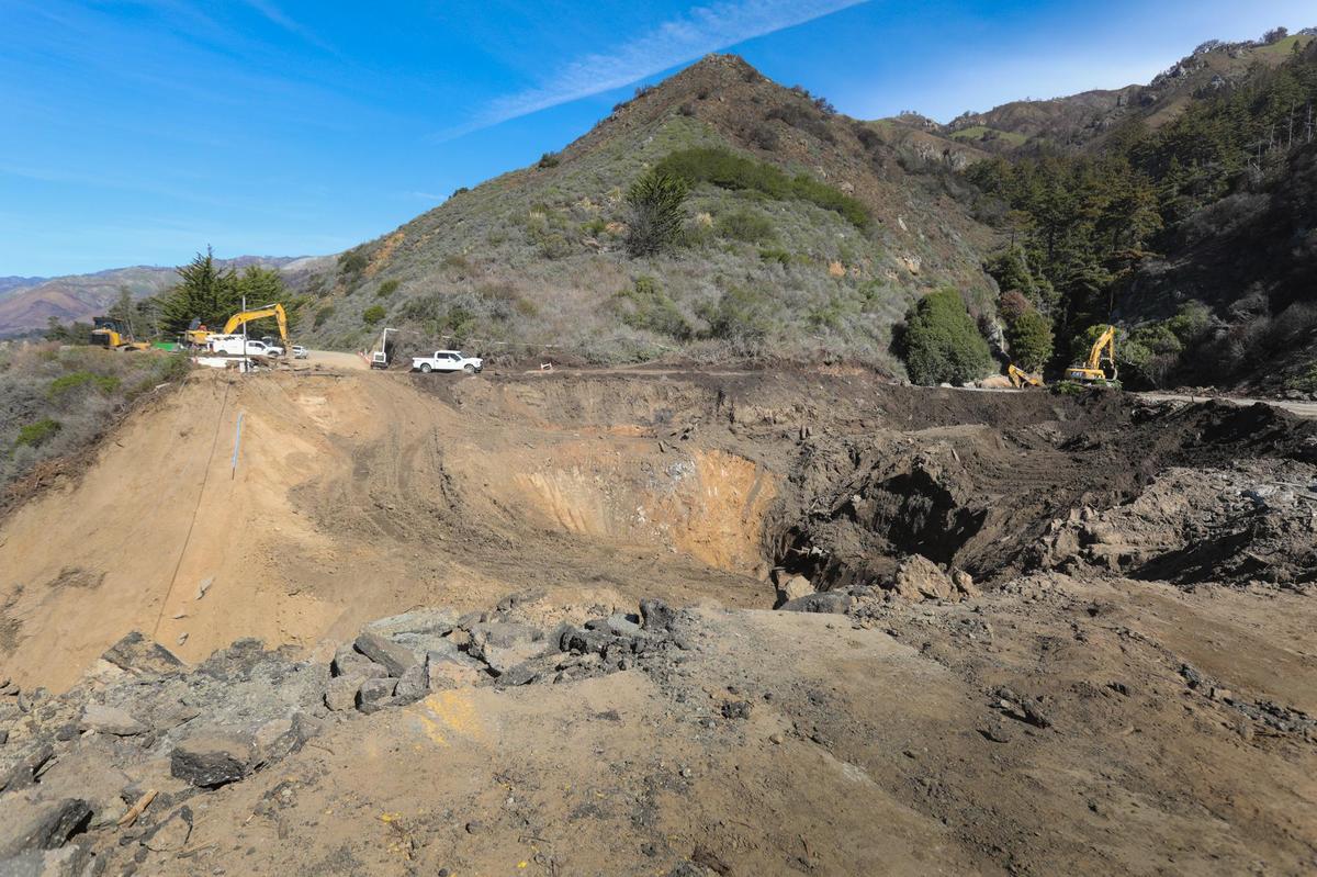 Trucks haul away debris from Rat Creek site.