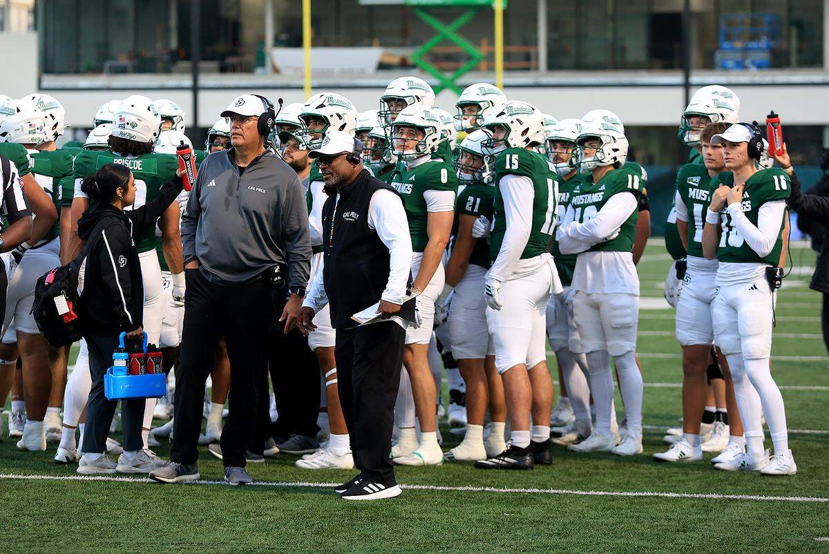 Cal Poly head coach Paul Wulff confers with the players. Cal Poly fell to Montana State 34-17 in a college football game at Mustang Memorial Field on Oct. 25, 2025.