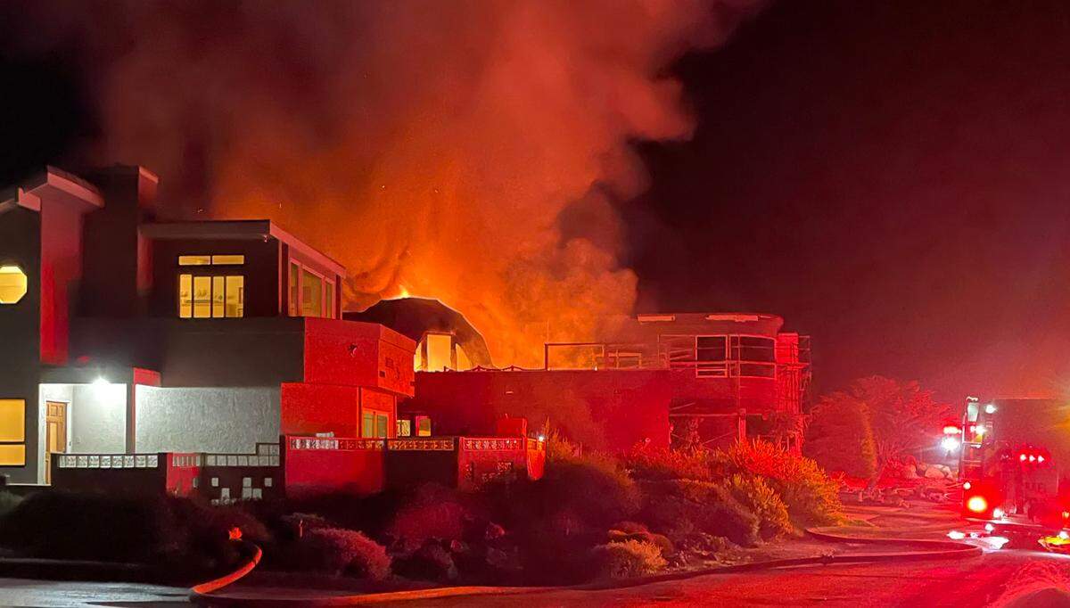 Firefighters respond to a residential fire on the 1900 block of Sherwood Drive in Cambria on Thursday, Oct. 20, 2022. The fire burned a home known for its two domes and also spread to a neighbor’s house.