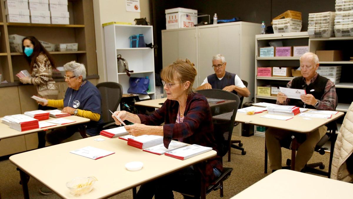 San Luis Obispo County Elections Office workers process vote-by-mail ballots on Wednesday, Nov. 9, 2022, the day after Election Day.