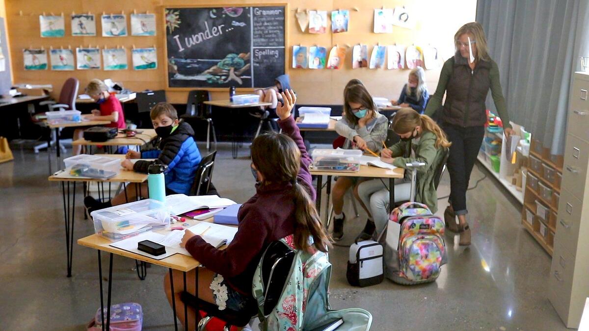 San Luis Obispo Classical Academy teacher Ronelle Volk walks among socially distanced desks to help her fourth-grade students with their math lesson. The campus is one of a few private schools in the county to reopen its doors to K-12 students during the coronavirus pandemic in October 2020.