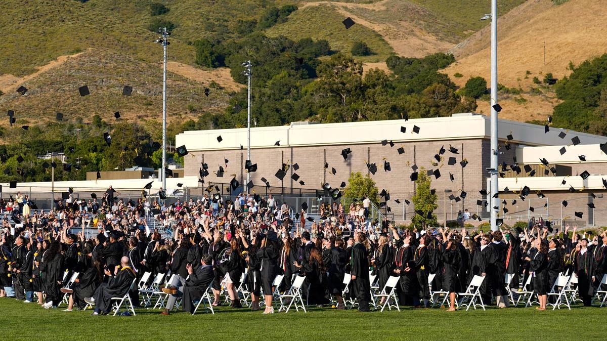 Members of the San Luis Obispo High School class of 2025 throw their graduation caps to the sky during commencement ceremonies at Holt Field on Friday, June 6, 2025.
