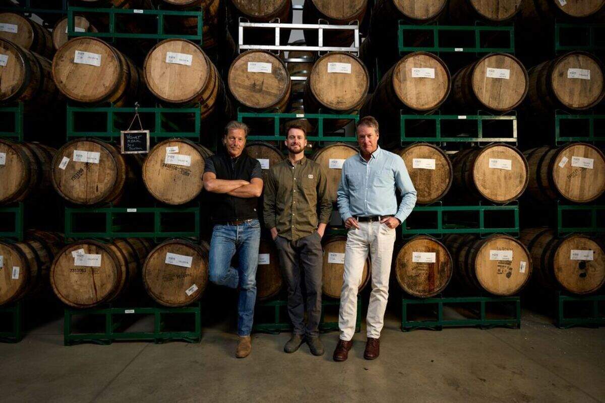 Firestone Walker Brewing Company’s founders David Walker, left, and Adam Firestone bookend their brewmaster Matt Brynildson in the barrel room.