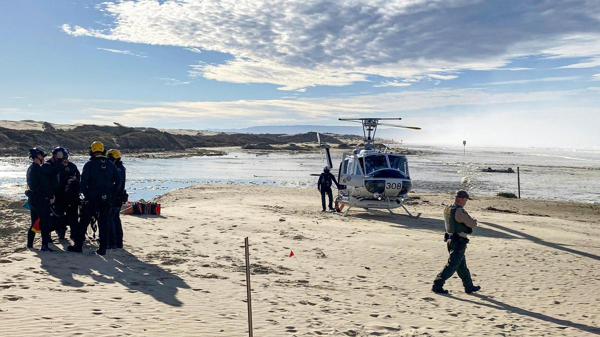Santa Barbara County sent one of three helicopters for rescue assignments at Oceano Dunes SVRA Dec. 28, 2023. A truck that attempted to cross Arroyo Grande Creek is in background.