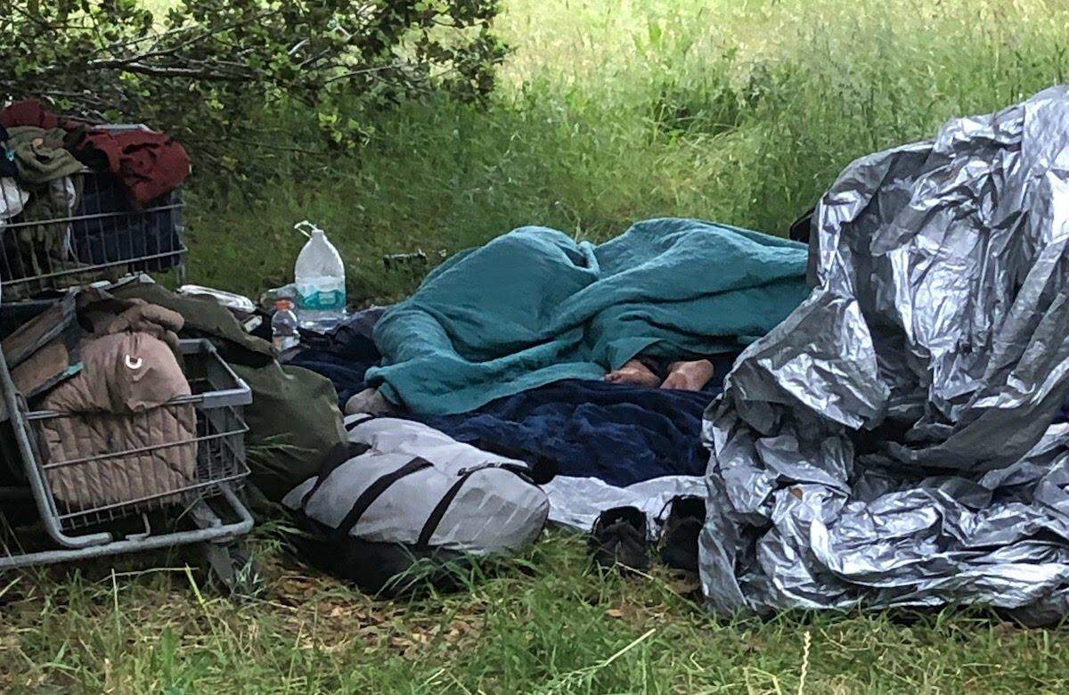Sheryl Glidden, a lifelong resident of San Luis Obispo County, rests at her campsite in Laguna Lake Park, prior to her death while homeless on April 30, 2024. Glidden was found on a Laguna Lake trail by San Luis Obispo resident Brett Cross, who attended San Luis Obispo High School with Glidden.