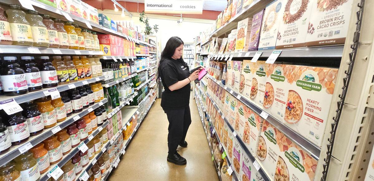 Grocery manager Joslyn Perez checks inventory in one of the aisles at the SLO Food Co-op in San Luis Obispo.