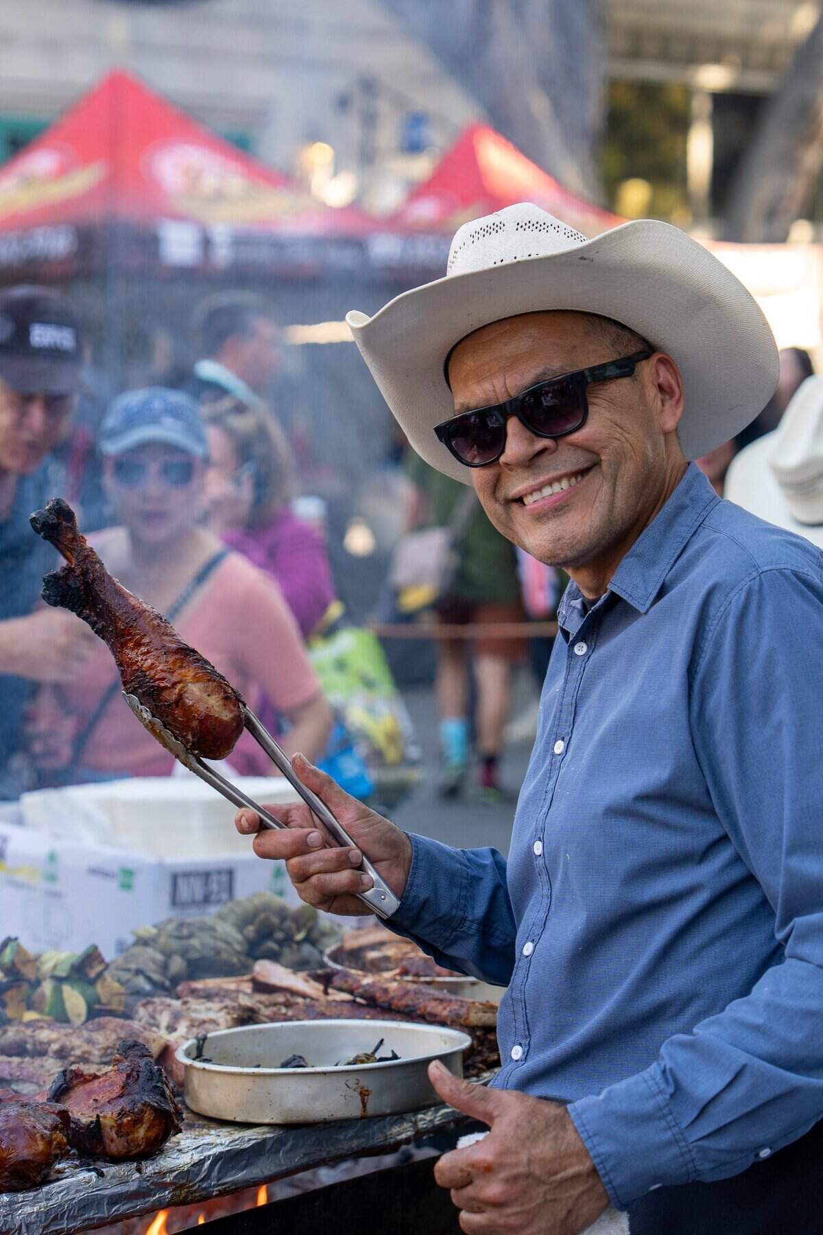 Victor Albarran, owner of Vix Creek Saloon, grills a chicken leg at the restaurant’s booth at the Downtown SLO Farmers Market on June 25, 2025. Albarran, a former F. McLintocks employee, opened his restaurant in the former McLintocks location in Arroyo Grande, and now occupies McLintocks space at the market.