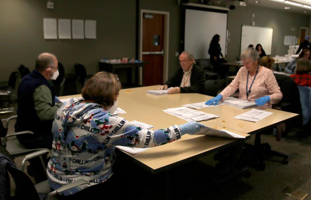 Volunteers sort ballots in an auxiliary room at the Katcho Achadjian Government Center on Tuesday, Dec. 20, 2022 as the recount of the District 2 supervisor race began.