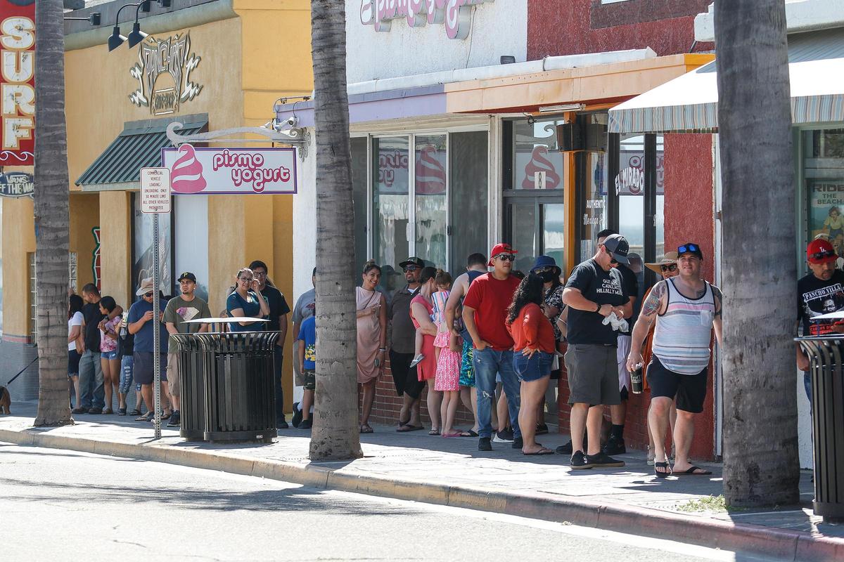 Hot weather drew big crowds to Pismo Beach on a warm April weekend. Many were not using proper social distancing, and only a few were wearing masks.