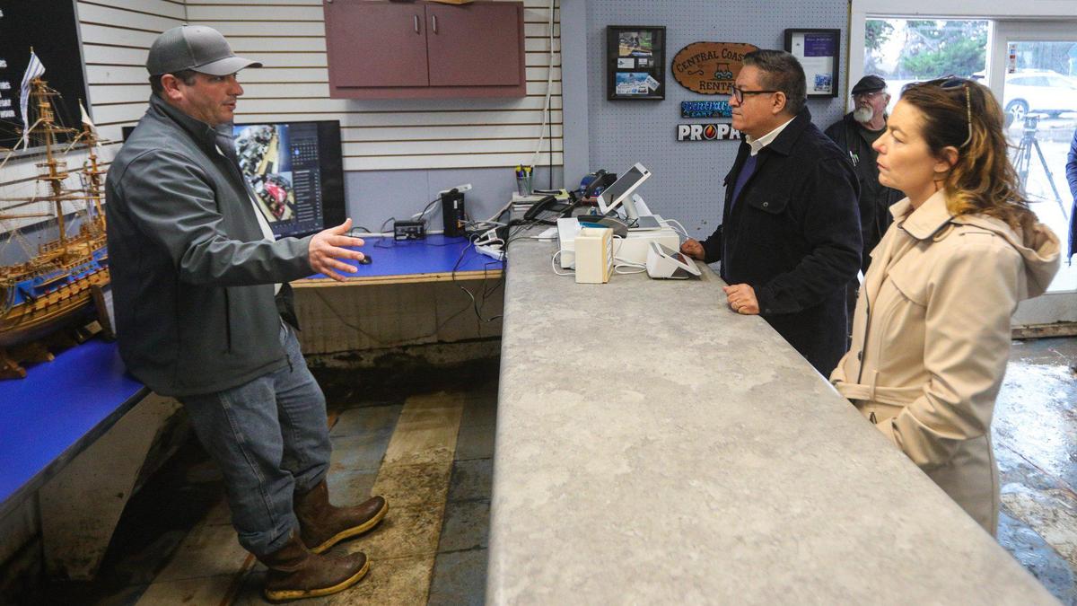 Jeff Babb, owner of Central Coast Carts in Morro Bay, talks about the flooding at his business with Congressman Salud Carbajal and Assemblymember Dawn Addis  on Jan. 16, 2023, during a tour of storm damage in Morro Bay and Los Osos.