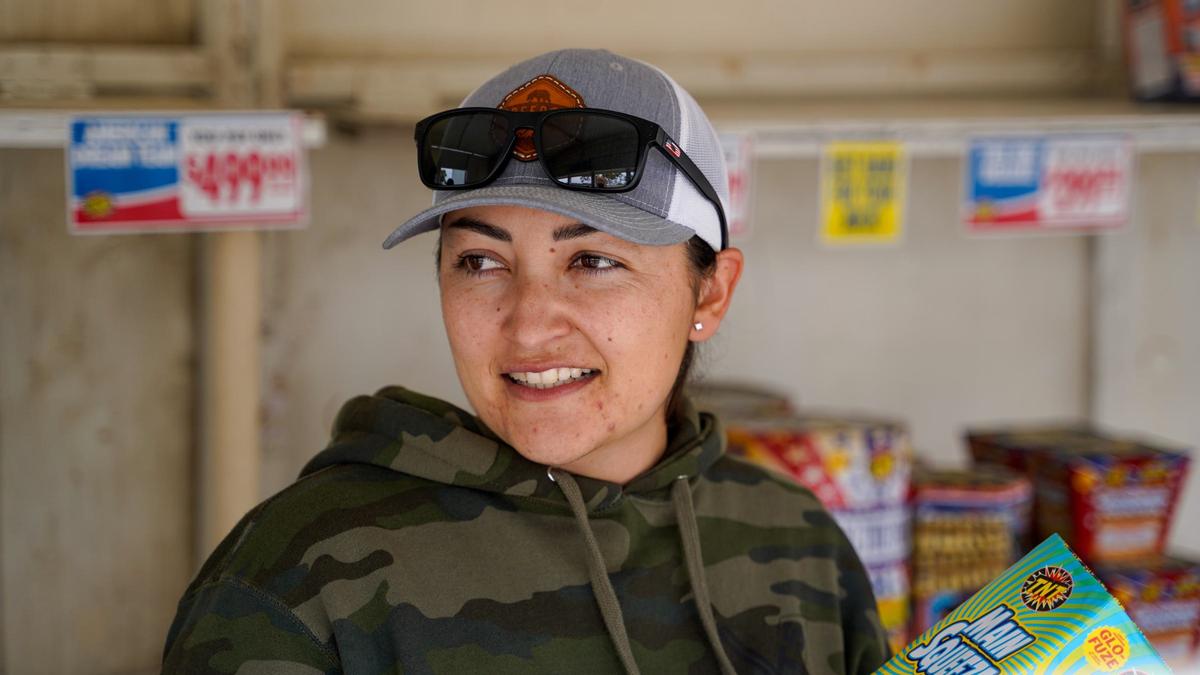 Arroyo Grande Police Department Senior Police Officer Elia Esparza sets up a TNT Fireworks stand on East Grand Avenue Friday, June 28, 2024. Esparza and other volunteers from the Police Officers’ Association worked the firework stand as a fundraiser.