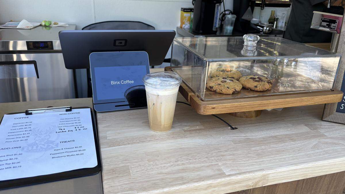 A caramel latte with coconut cream sits on the counter window of Binx Coffee in Atascadero.