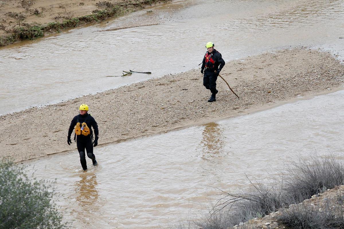 Searchers check through floodwaters for any sign of 5-year-old Kyle Doan on Wednesday, Jan. 11, 2023, two days after he disappeared in swollen San Marcos Creek near San Miguel.