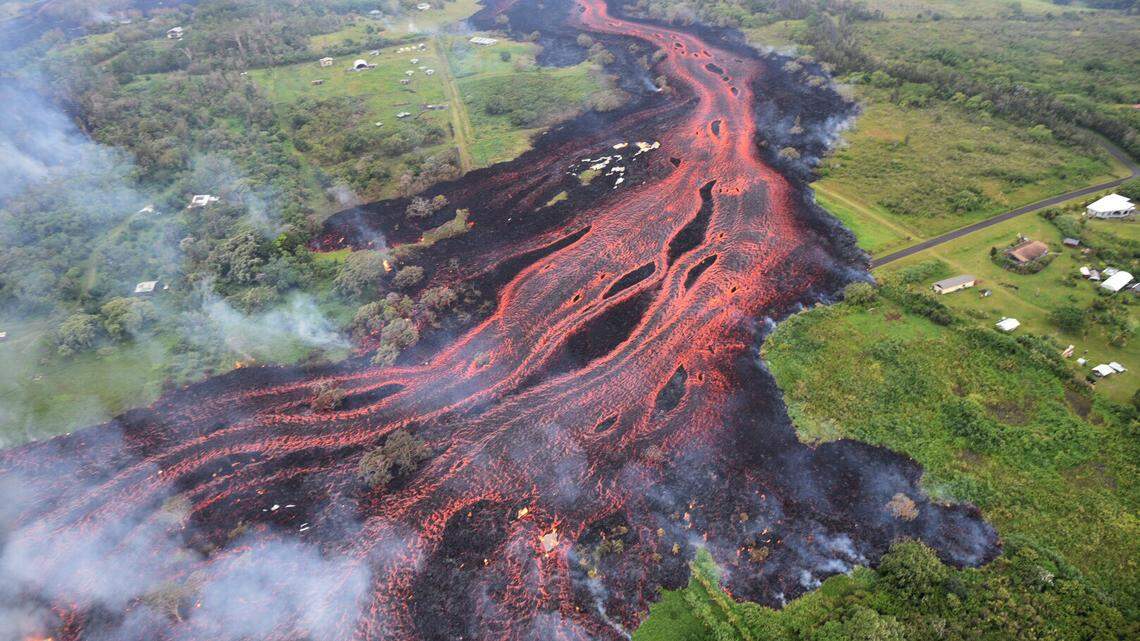 In this Saturday, May 19, 2018, photo released by the U.S. Geological Survey, lava flows from fissures near Pahoa, Hawaii. Kilauea volcano began erupting more than two weeks ago and has burned dozens of homes, forced people to flee and shot up plumes of steam from its summit that led officials to distribute face masks to protect against ash particles.