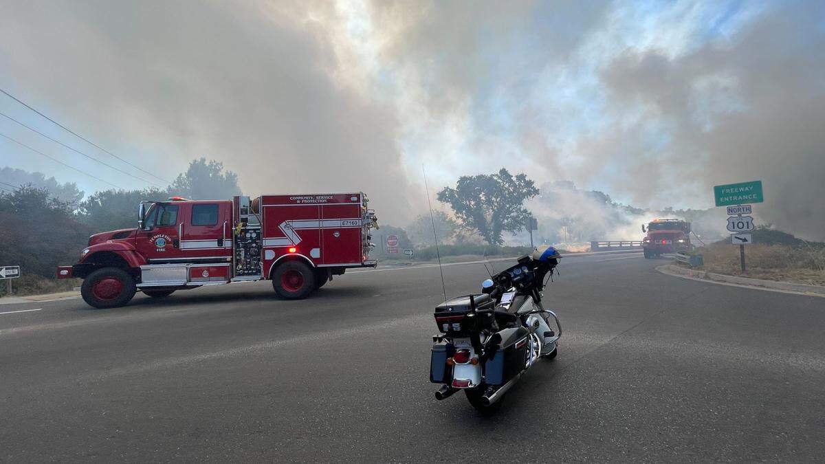 Smoke billows over San Anselmo Road in Atascadero as firefighters respond to the vegetation fire along Highway 101 on July 15, 2023.