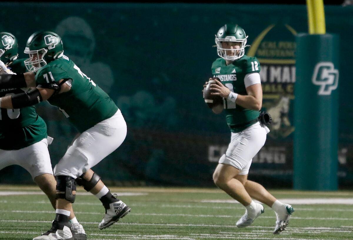 Cal Poly quarterback Jackson Akins looks for a receiver. Cal Poly lost to Northern Arizona 31–14 in a college football game at Mustang Memorial Field on Nov. 9, 2024.