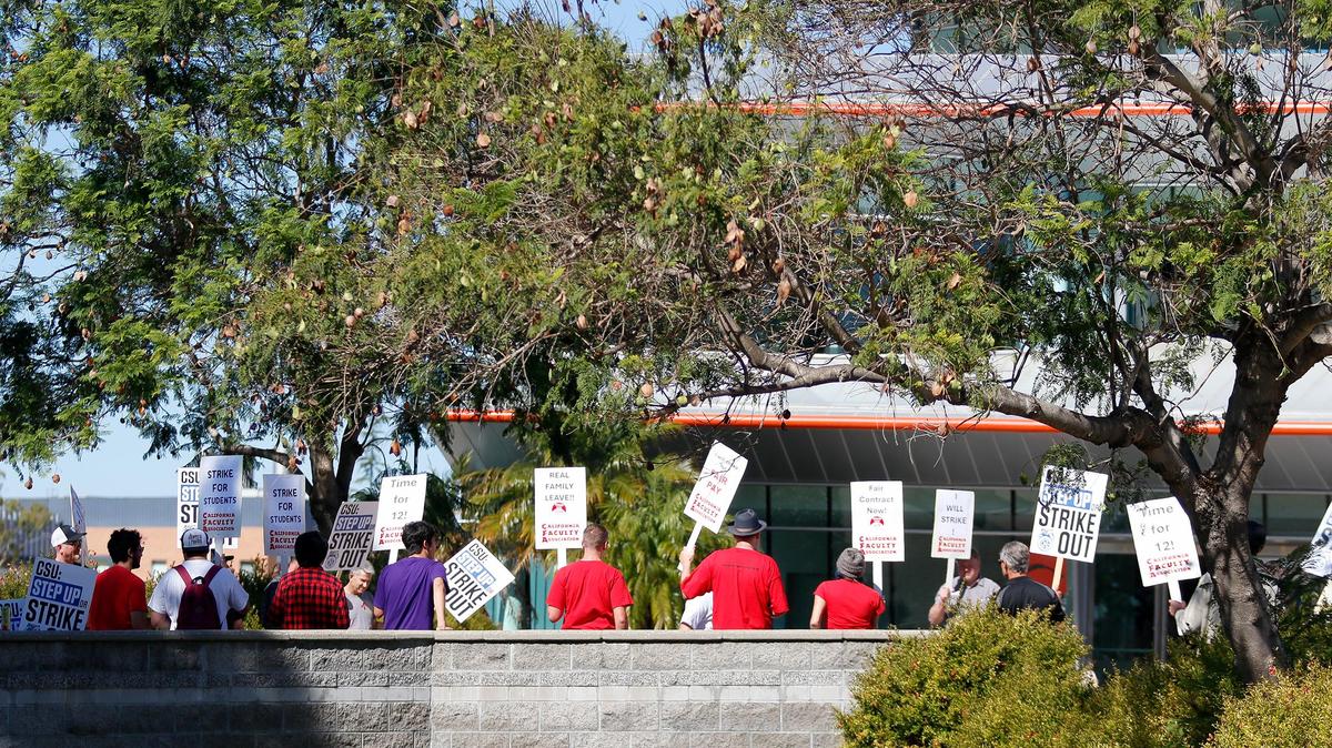 Members of the California Faculty Association picket outside a Cal Poly alumni event at the Performing Arts Center on Friday, Oct. 27, 2023, in support of higher state university salaries.