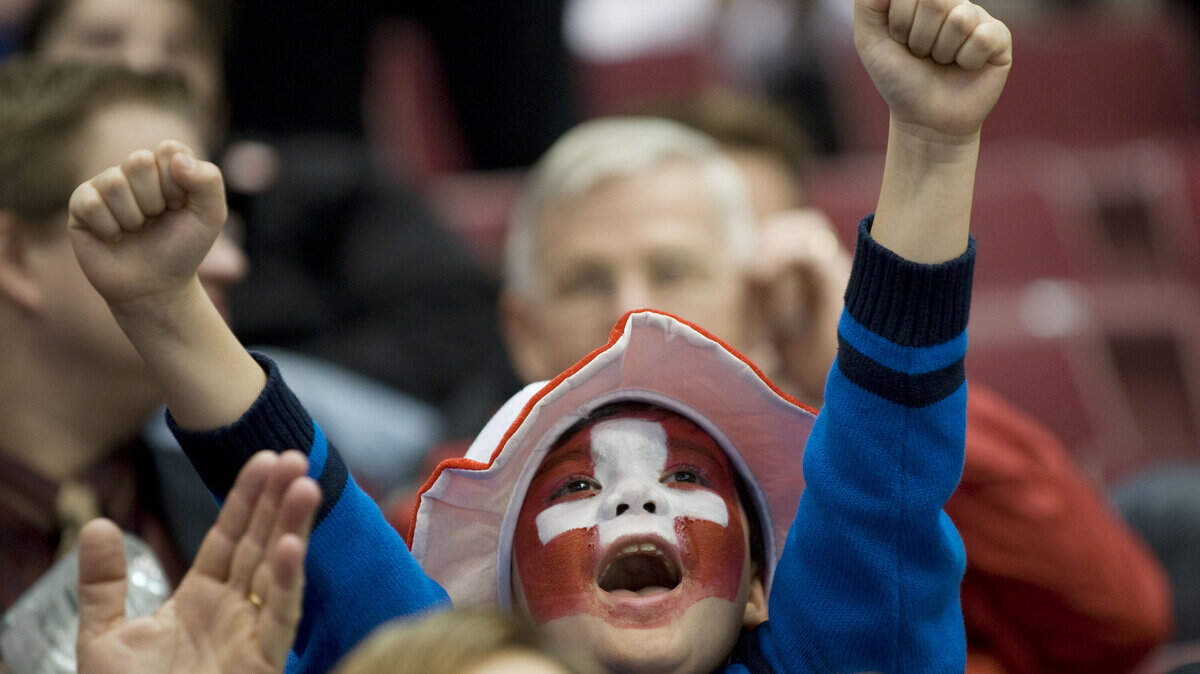 A young Swiss fan cheers on his team during a 3-2 shootout victory over Belarus. (Kevin Sullivan/Orange County Register/MCT)