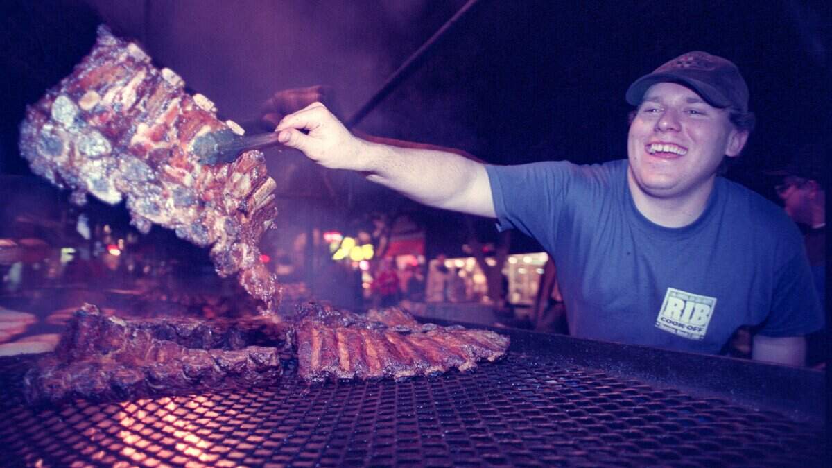 Matt Eggen of the Old Country Deli flips a large side of ribs during the 11th annual Rib Cook-off in downtown San Luis Obispo on March 20, 1996.