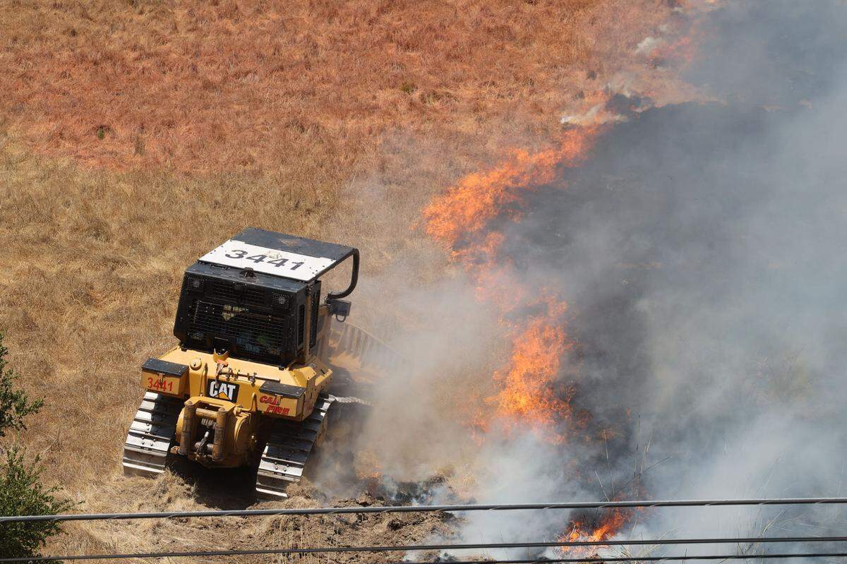 A Cal Fire dozer responds to a vegetation fire burning on a hill on the southbound side of Highway 101 and Hawk Hill Lane at the base of the Cuesta Grade in San Luis Obispo on Sept. 3, 2024.