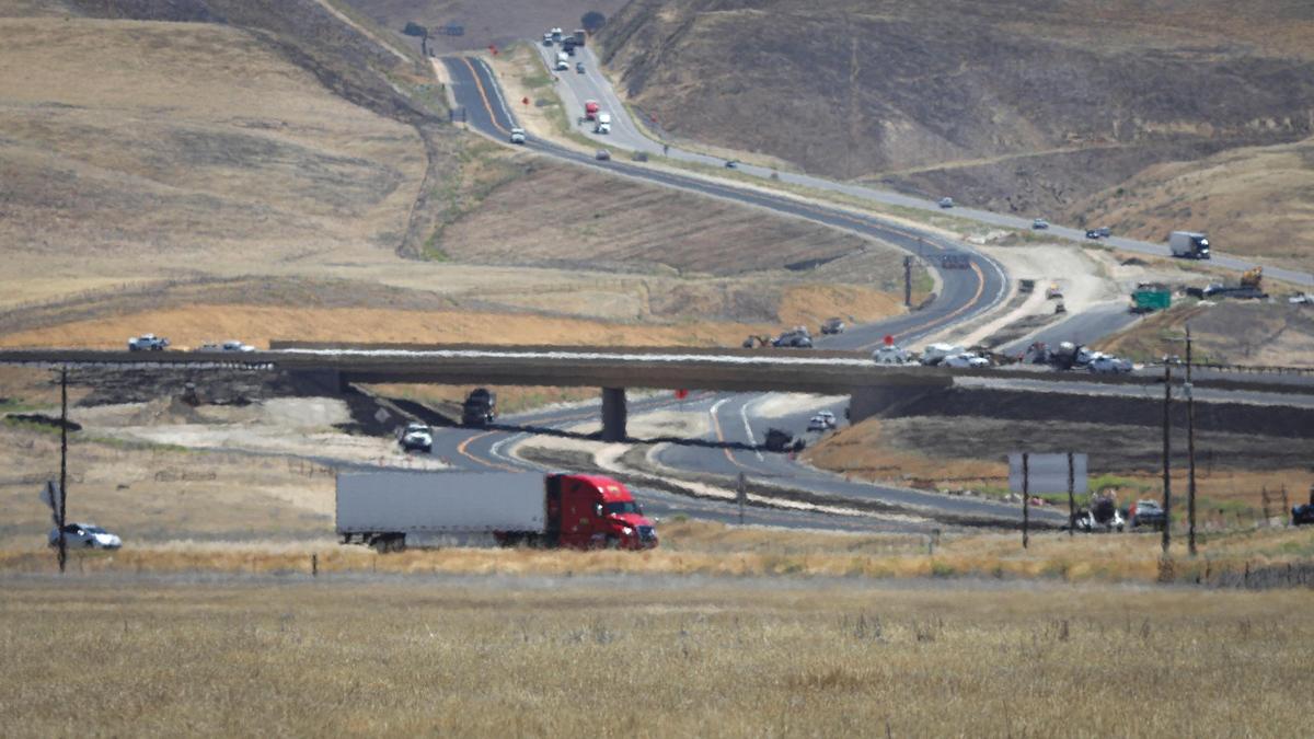 New crossiong where Highway 41 crosses Highway 46 is under construction. Red semi-truck travels the curent Highway 41, Highway 46 in upper center of image. Construction continues on the new interchange at the Y where Highway 41 from Fresno meets Highway 46 between Paso Robles and Bakersfield, seen on June 3, 2025.