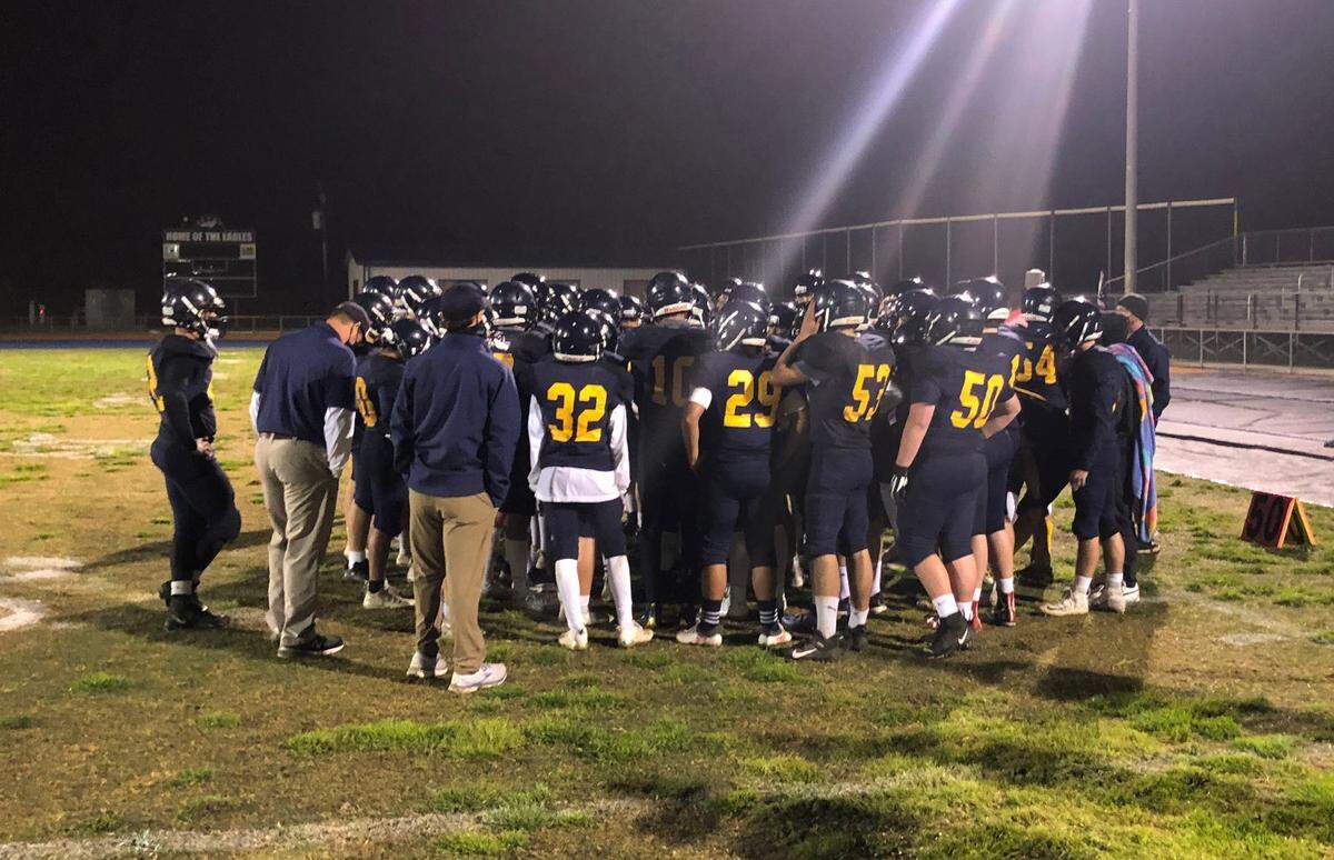 The Arroyo Grande High football team gathers on the field after a win over Atascadero.