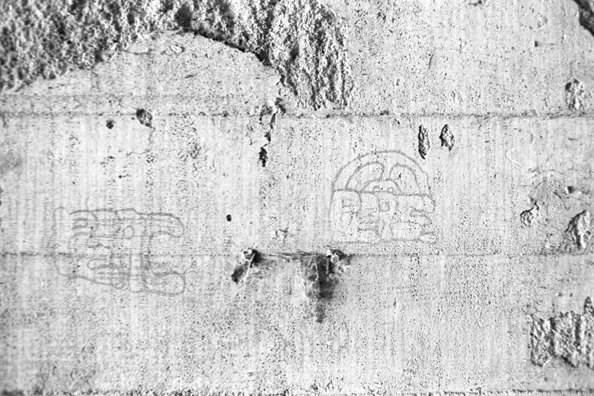 Graffiti on a concrete wall lining San Luis Creek. It flows under the city for a little over two blocks below and adjacent to Higuera Street. Most of the path is unlit darkness. This view is from Sept. 5, 1975.