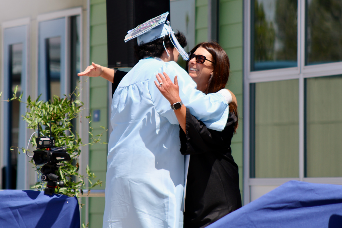 Alexander Zarate and counselor Laura Ortiz share an embrace at Central Coast New Tech High School’s graduation ceremony on Saturday, June 6, 2026.