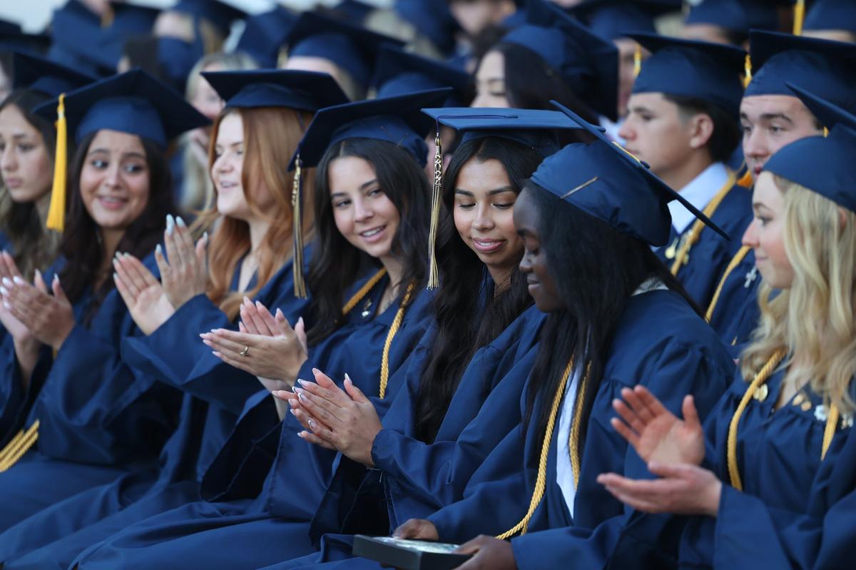 Praise Yawe is applauded as she stands to deliver her valedictory address. Mission College Prep awarded diplomas to 69 graduates on the steps of Mission San Luis Obispo on May 31, 2024.