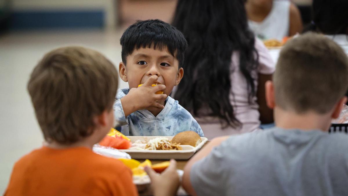 Leonardo Garcia Vazquez, 7, has an orange slice on a warm day. Fresh and local is on the menu for healthier school lunches as students at Lillian Larsen Elementary in San Miguel eat on Aug. 22, 2022.