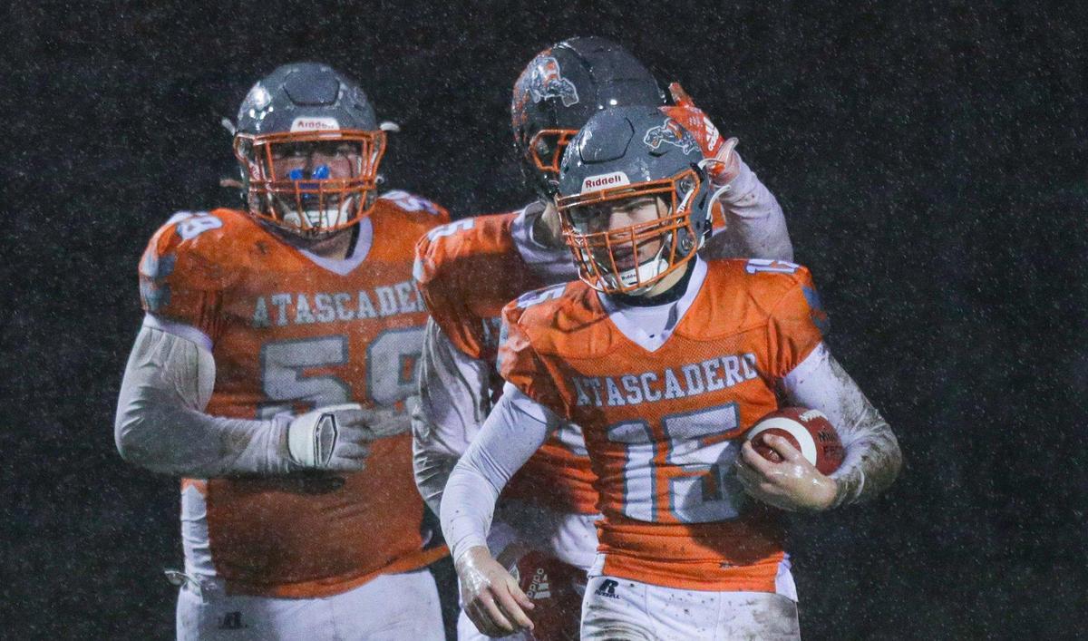 Kane Cooks gets pats on the back after scoring a first-quarter touchdown. The Atascadero Greyhounds beat the San Gabriel Matadors 41-0 to win the CIF Division 6-A State Championship football game on Dec. 10, 2022.
