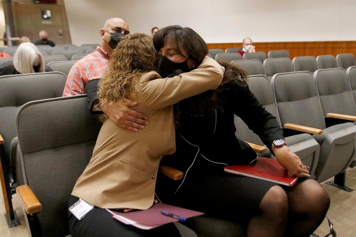 Helen Nolan, left, hugs Elaina Cano after the San Luis Obispo Board of Supervisors selected Cano as interim clerk-recorder on Tuesday, Oct. 12, 2021.