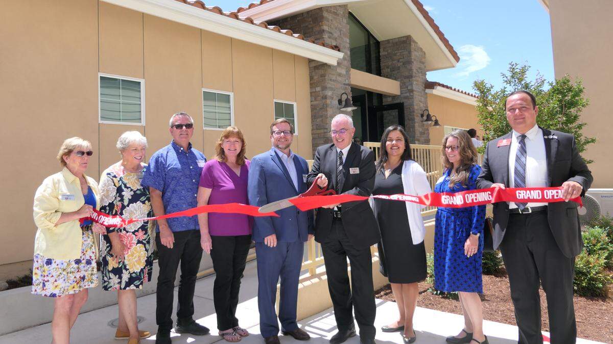 People’s Self-Help Housing CEO Ken Triguiero, center, cuts the ribbon on Templeton Place II, a new affordable housing complex. Templeton Place II consists of 36 units that serve seniors and veterans, with 10 units permanently set aside for formerly homeless veterans.