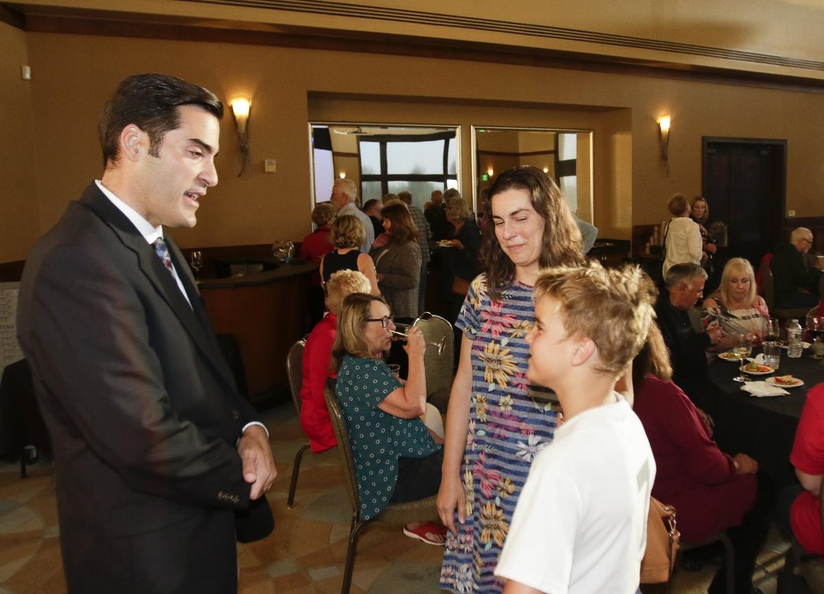 Jimmy Paulding speaks to supporters Spencer Todd, 10, and his mother Julia Todd at an election night party in Nipomo.