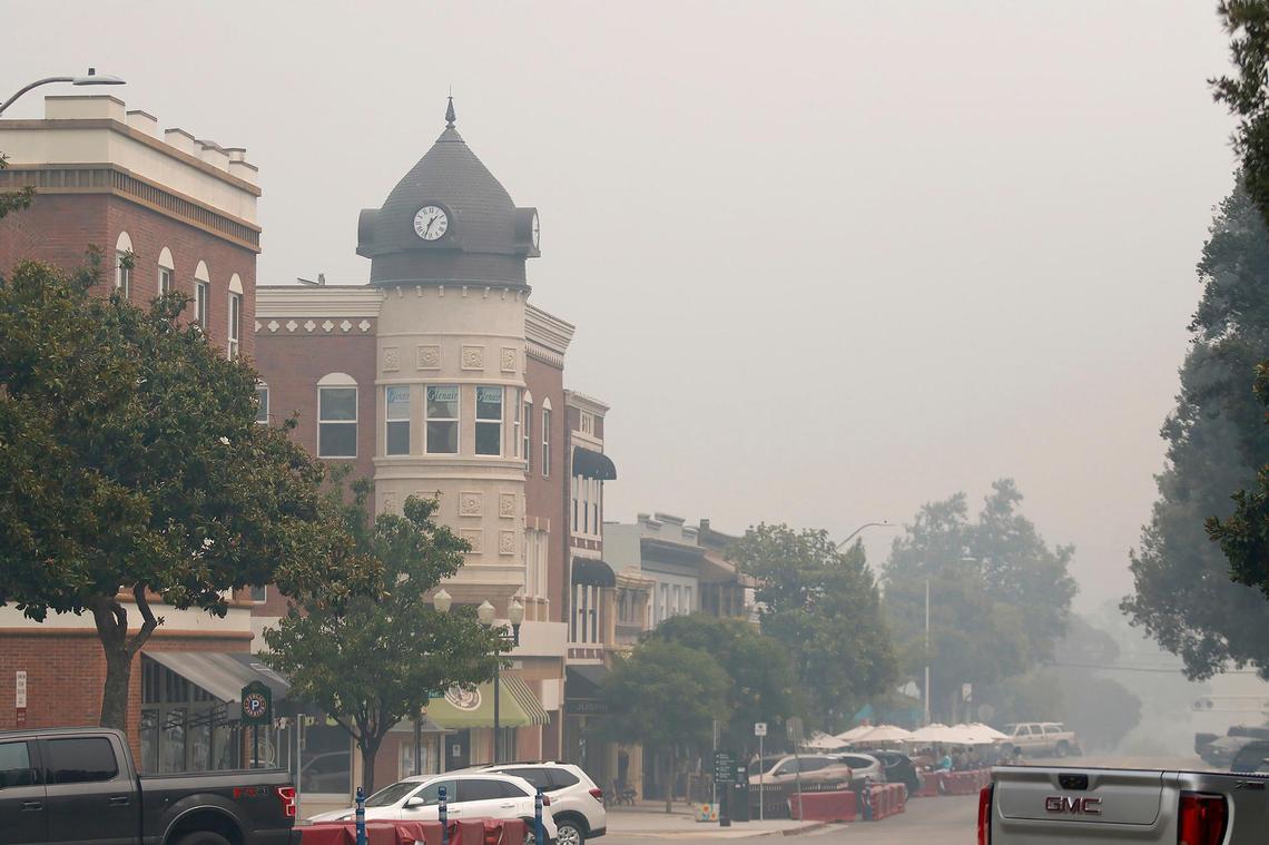 Thick smoke fills downtown Paso Robles on Thursday in a view looking down 12th Street past the Acorn building.