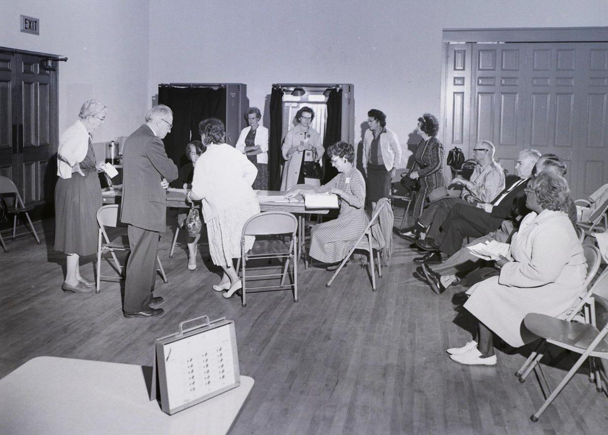 Voters, in this undated photo from the 1960s, sit and wait for a voting machine to become available at the Veterans Memorial Hall in San Luis Obispo. The machines were in use for elections from 1958-1975 but in the 1962 primary election machines jammed and caused lines at the polls. Training machines set on tables to help teach the process