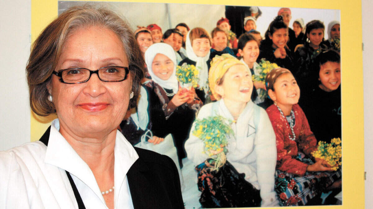Social Science Professor Maliha Zulfacar in her Cal Poly office this month, 2-2010. The photo behind her on the wall is a photo of children in Afghanistan. Ð Courtesy credit Cal Poly Public Affairs.