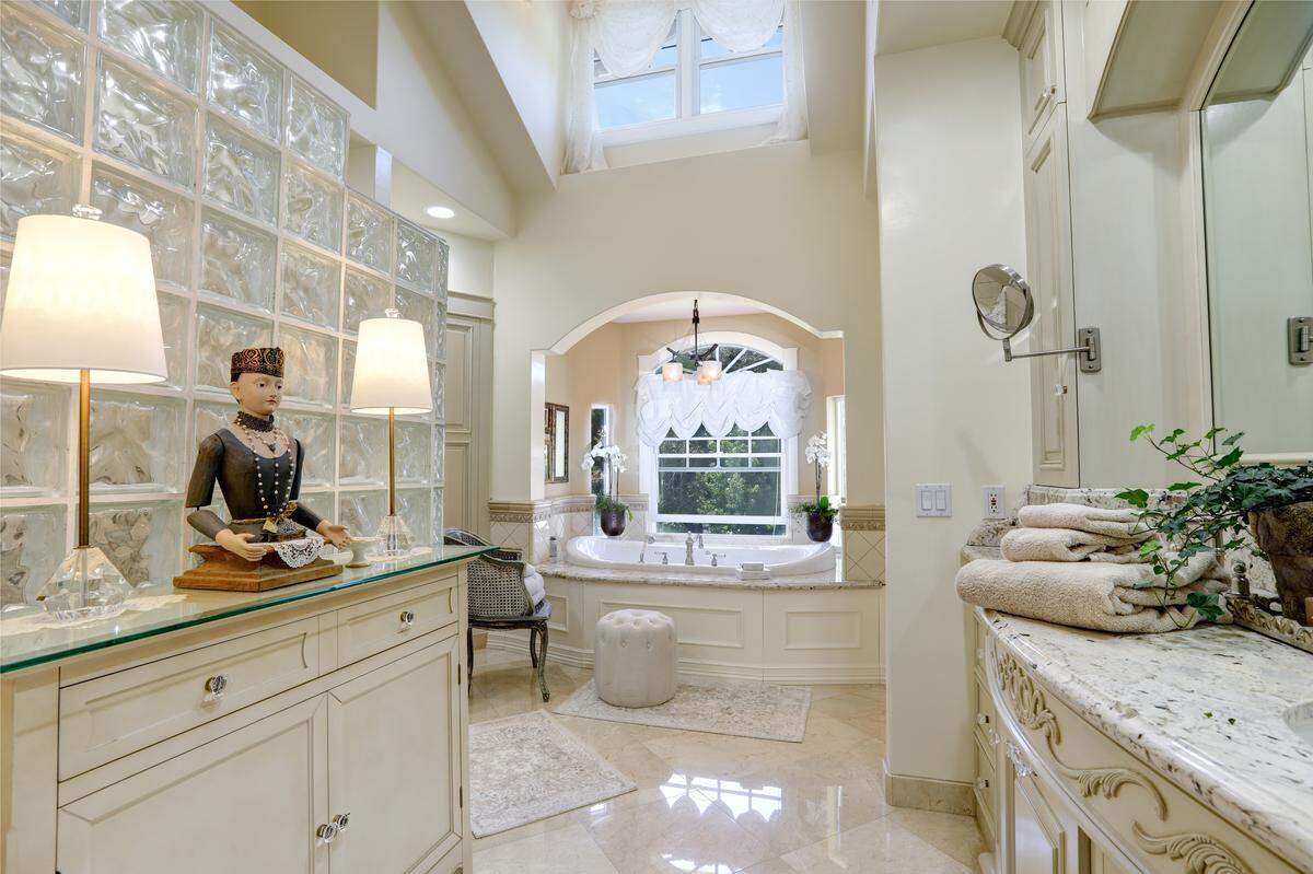 Marble tiles, a huge soaking tub, walk-in shower and granite countertops give the master bath at The Bee’s Knees Fruit Farm in San Luis Obispo a lavish feel.