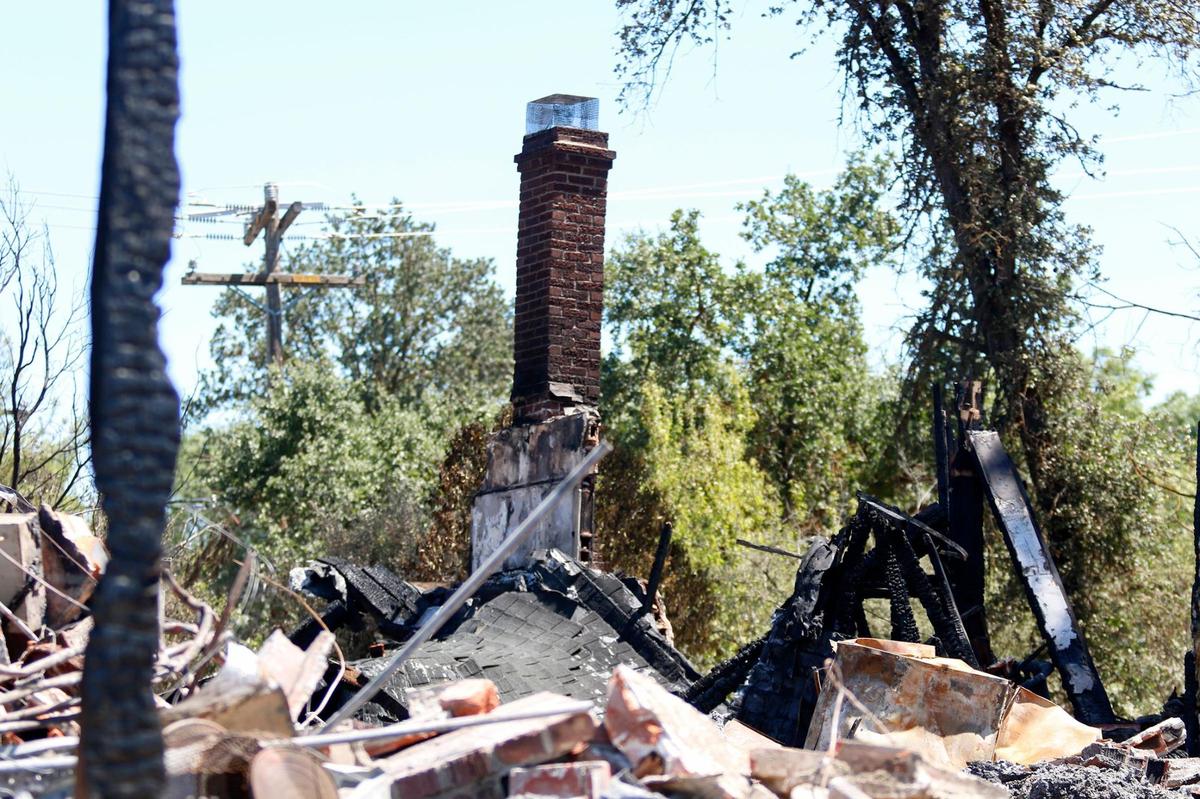 Only a chimney was standing in the rubble of the burned home on the 400 block of Creston Road in Paso Robles after the River Fire tore through the property on Monday.