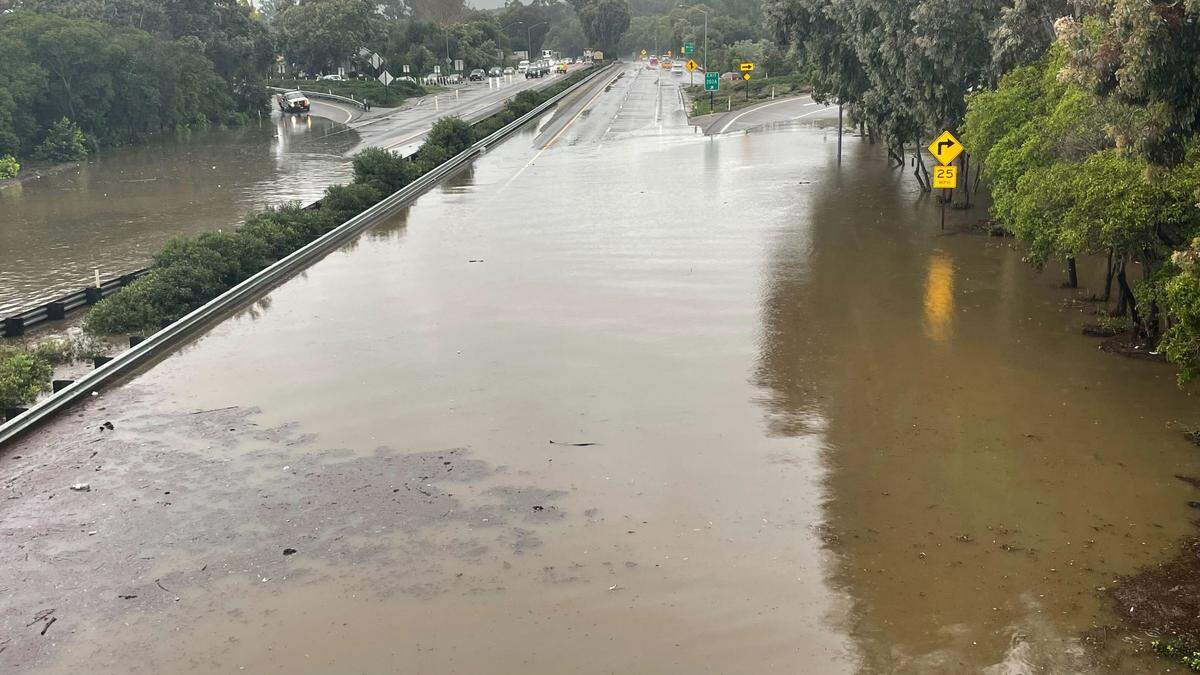 Highway 101 was under more than a foot of water under the Santa Rosa Street overpass in San Luis Obispo after a backed up drain flooded the road.