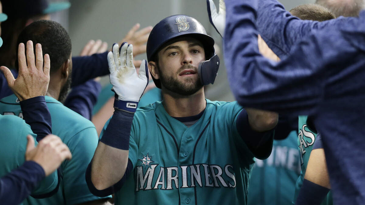 Seattle Mariners' Mitch Haniger is congratulated in the dugout after hitting a two-run home run against the Kansas City Royals during the fourth inning of a baseball game Friday, June 29, 2018, in Seattle.